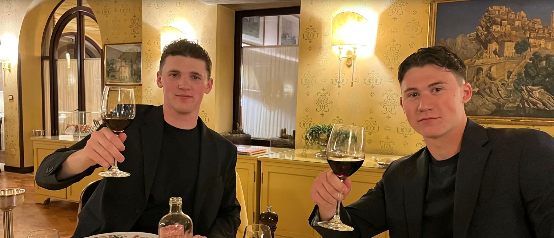 Lorenzo Staub and Francesco Domenech, the founders of Engadine Estates, raising a glass at a table